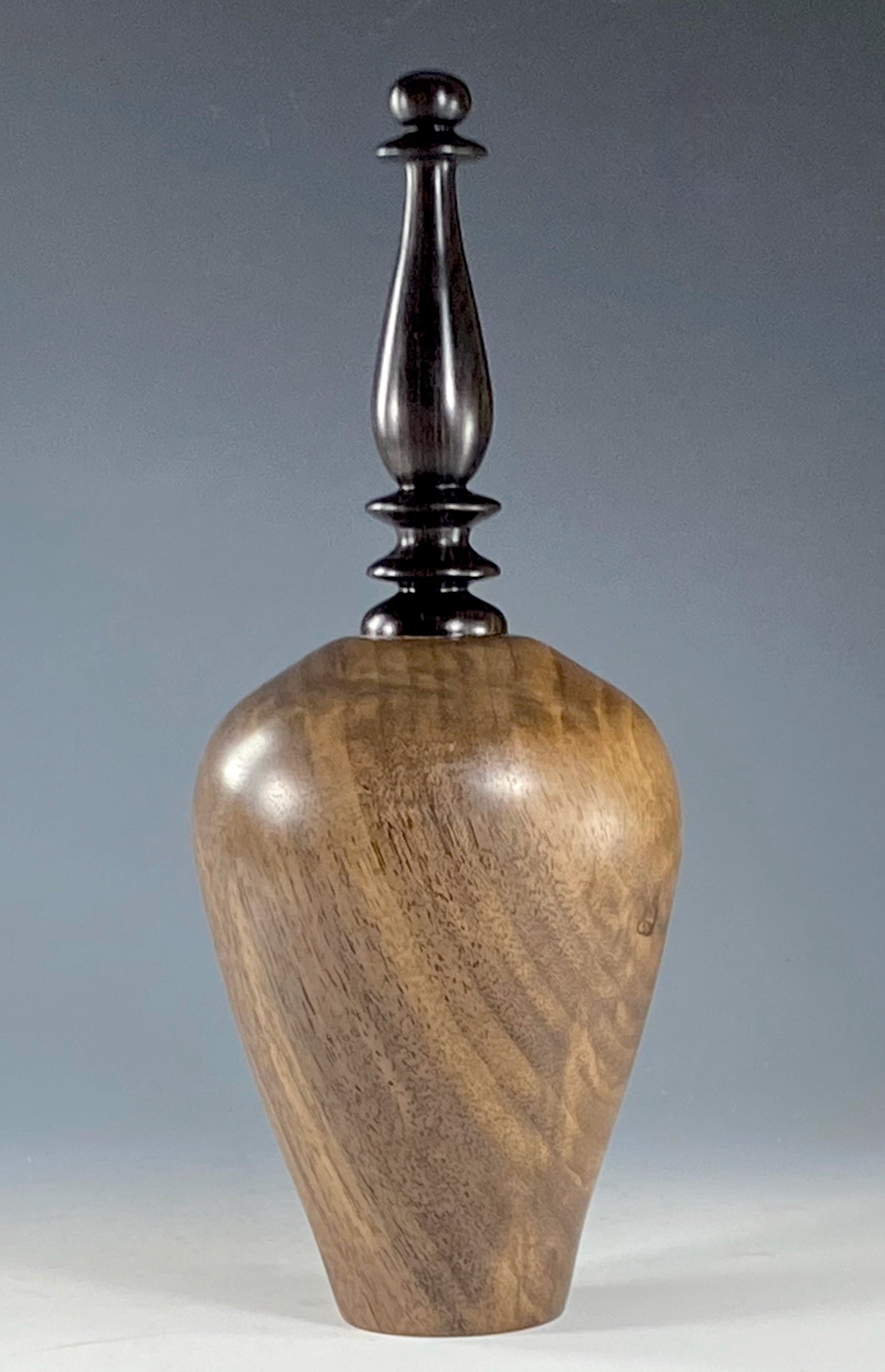 VESSEL TURNED FROM CLARO WALNUT, WITH AFRICAN BLACKWOOD FINIAL