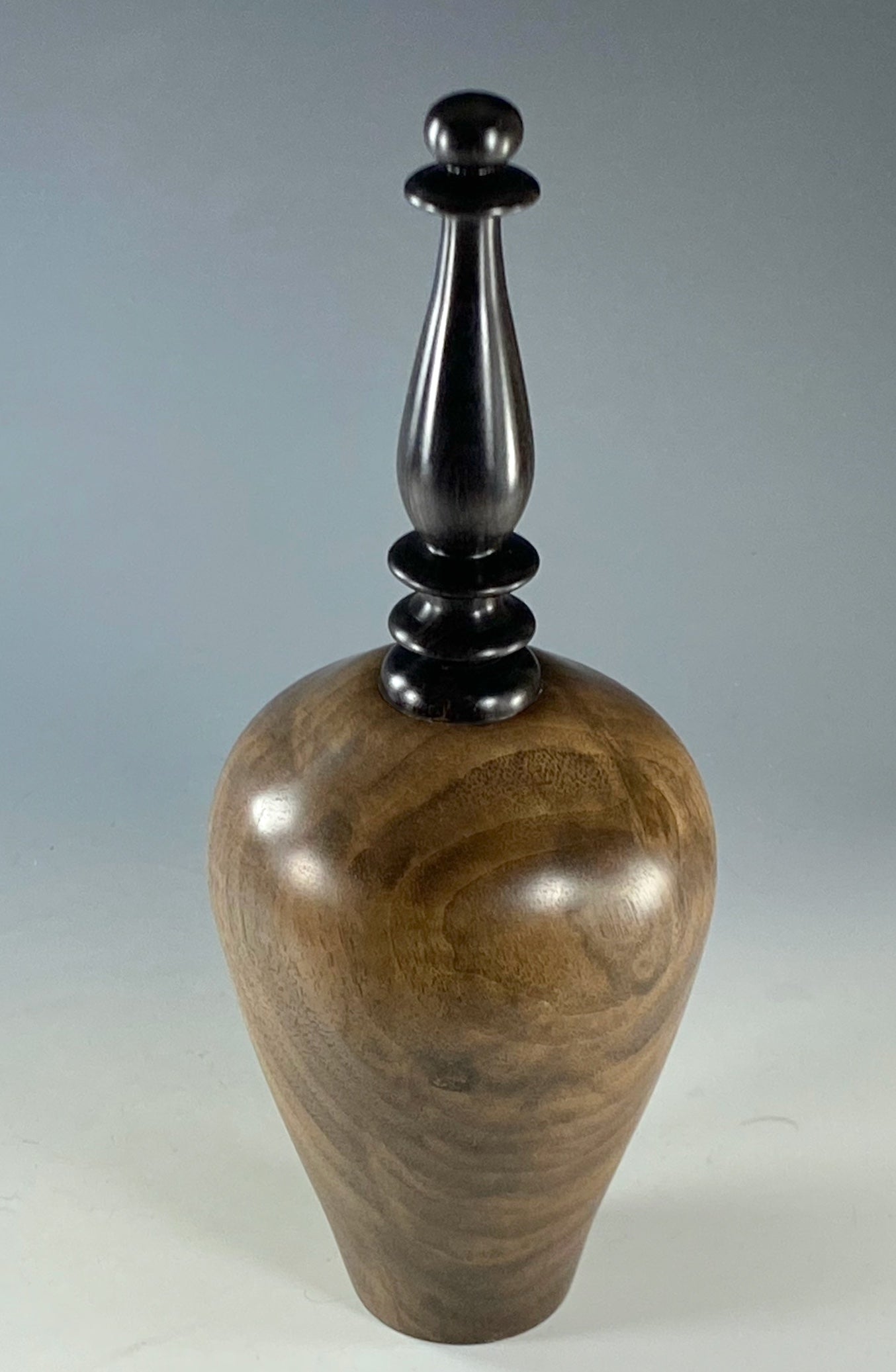 VESSEL TURNED FROM CLARO WALNUT, WITH AFRICAN BLACKWOOD FINIAL